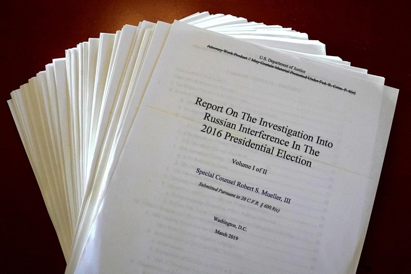 pages of the Mueller Report fanned out with the title page on top