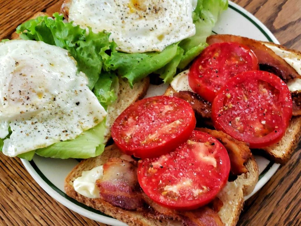 open-faced sandwich with bacon, lettuce, egg and beautiful summer tomatoes