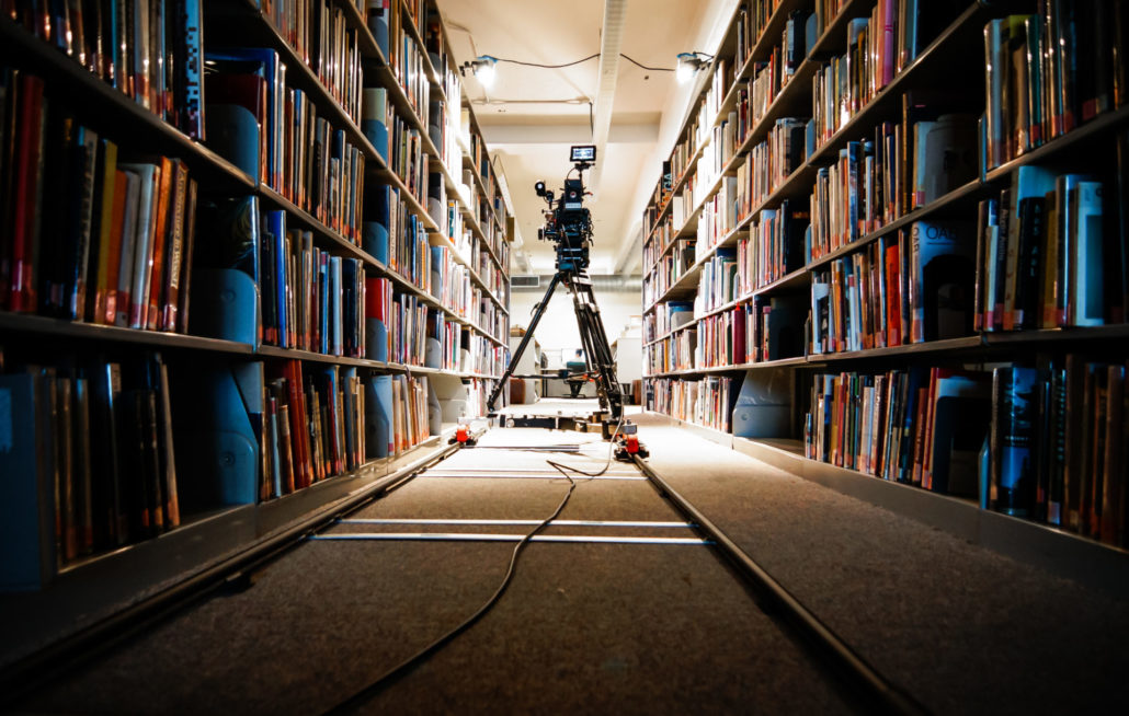 library with tripod camera for filming