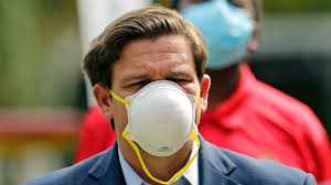 DeSantis wearing a mask the wrong way.