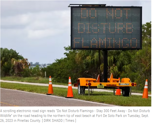 sign that warns people not to disturb flamingo