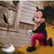 Mickey Mouse next to house with white shrimper boots sticking out