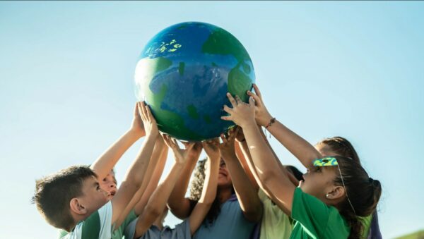 hands holding up the planet Earth