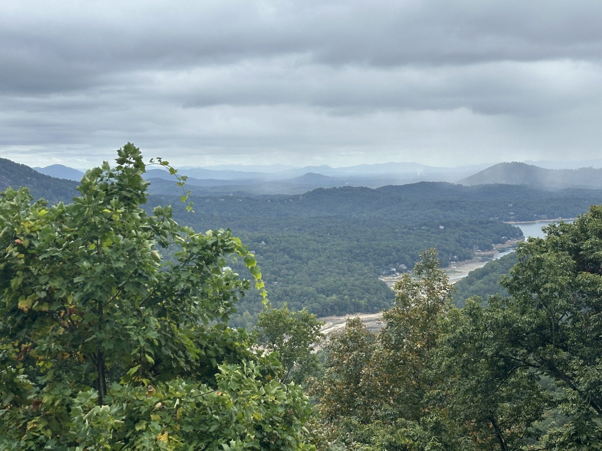 View of a misty mountain range with a river cutting through the valley. 