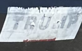 Faded remnants of a nearly illegible Trump bumper sticker. 
