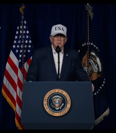 Sweaty, corpulent man in a blazer and white shirt wearing a dumb white trucker hat.