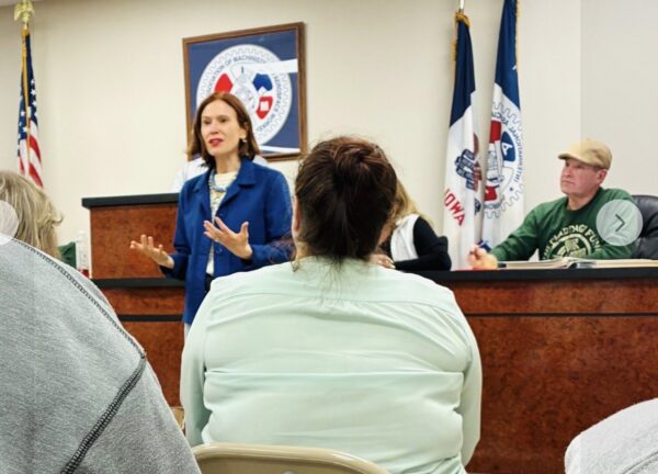 Grace speaking in front of a crowd