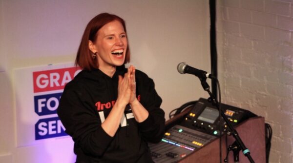Grace standing at mike during a townhall