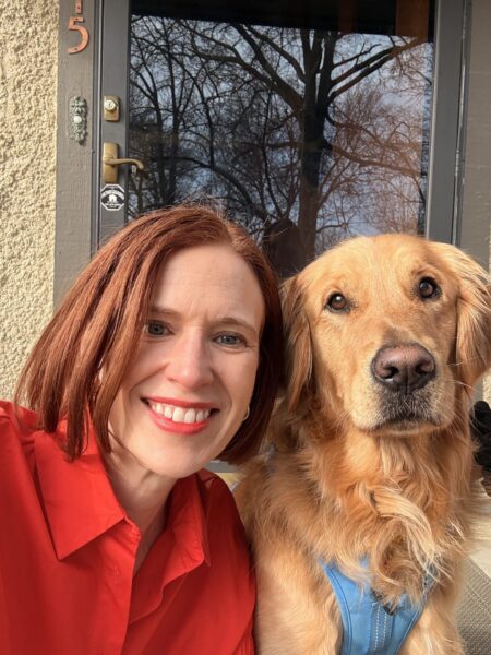 Grace in red posing with golden retriever in blue