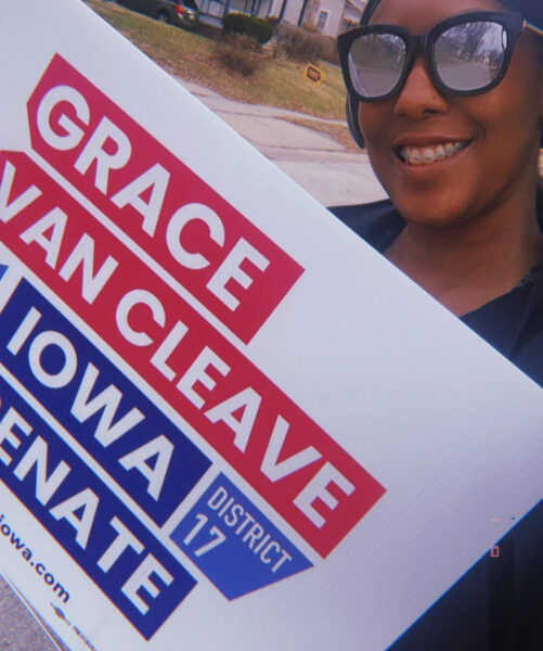 Woman holding Grace yard sign
