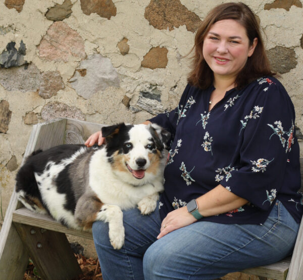 Amanda Bell sitting with her blue heeler mix